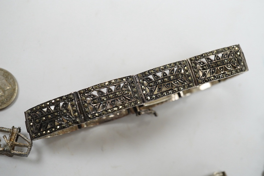 Two silver bracelets, a silver watch chain, a silver and marcasite bracelet and a similar watch. Condition - fair